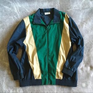 A Blue, Green, & Tannish Jacket that zips up.